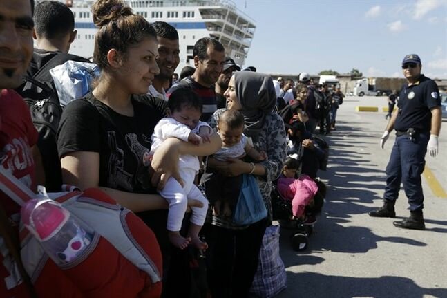 A Syrian mother, left, binds her one-month aged daughter as she waits for a train transporting them to a metro hire after their attainment from a Greek island of Lesbos during a Athens' pier of Piraeus, Monday, Sept. 28, 2015. The Greek packet Elefhterios Venizelos is partial of special packet use for refugees and migrants that carries 2,500 profitable passengers. More than 250,000 haven seekers have upheld by Greece so distant this year. (AP Photo/Thanassis Stavrakis)